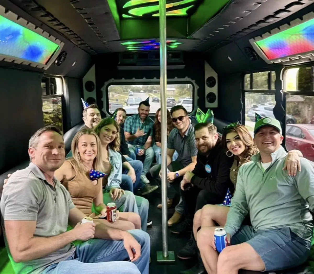 Group celebrating on an Austin Party Bus with LED lights and party hats