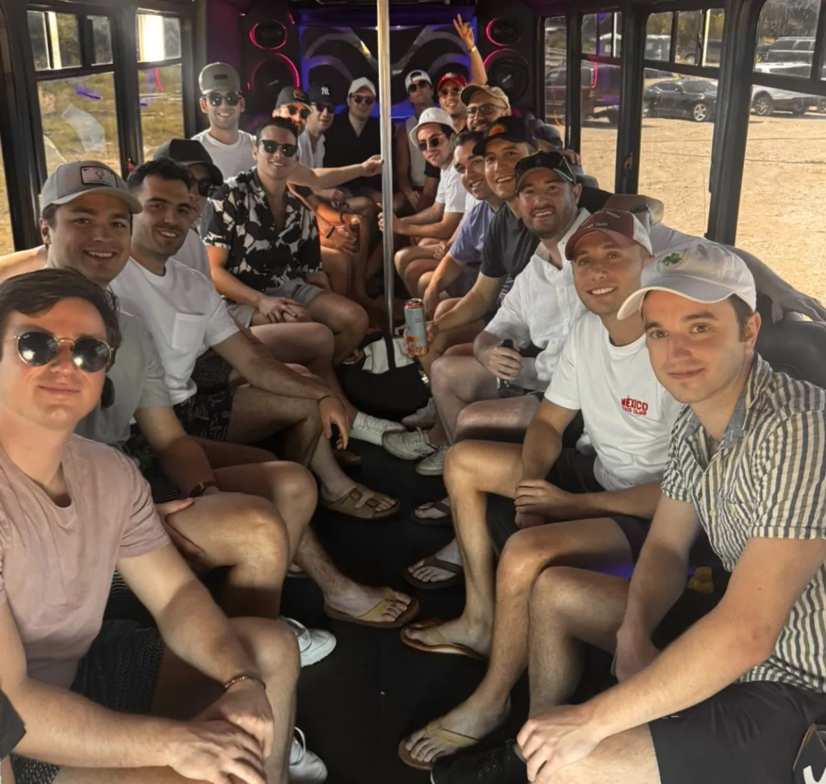 Bachelor party groom squad celebrating on an Austin Party Bus on a summer night out