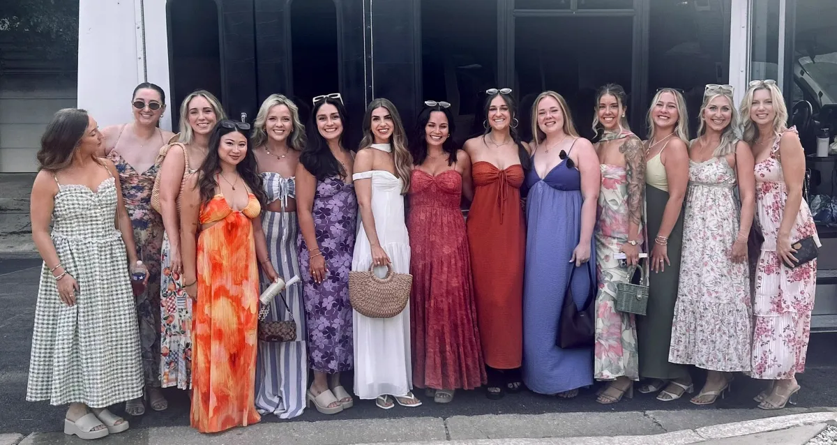 Bachelorette group lined up outside Austin Party Bus in sundresses