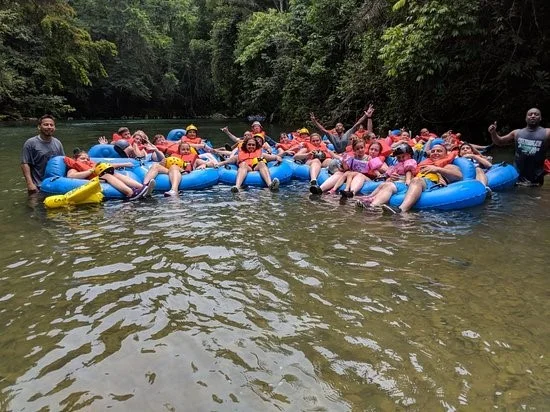 a group of people on a raft in a body of water